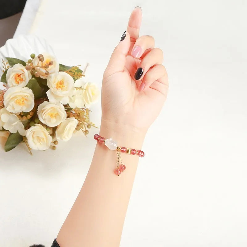 Handcrafted women's bracelet with strawberry quartz and agate beads featuring a white rabbit design.