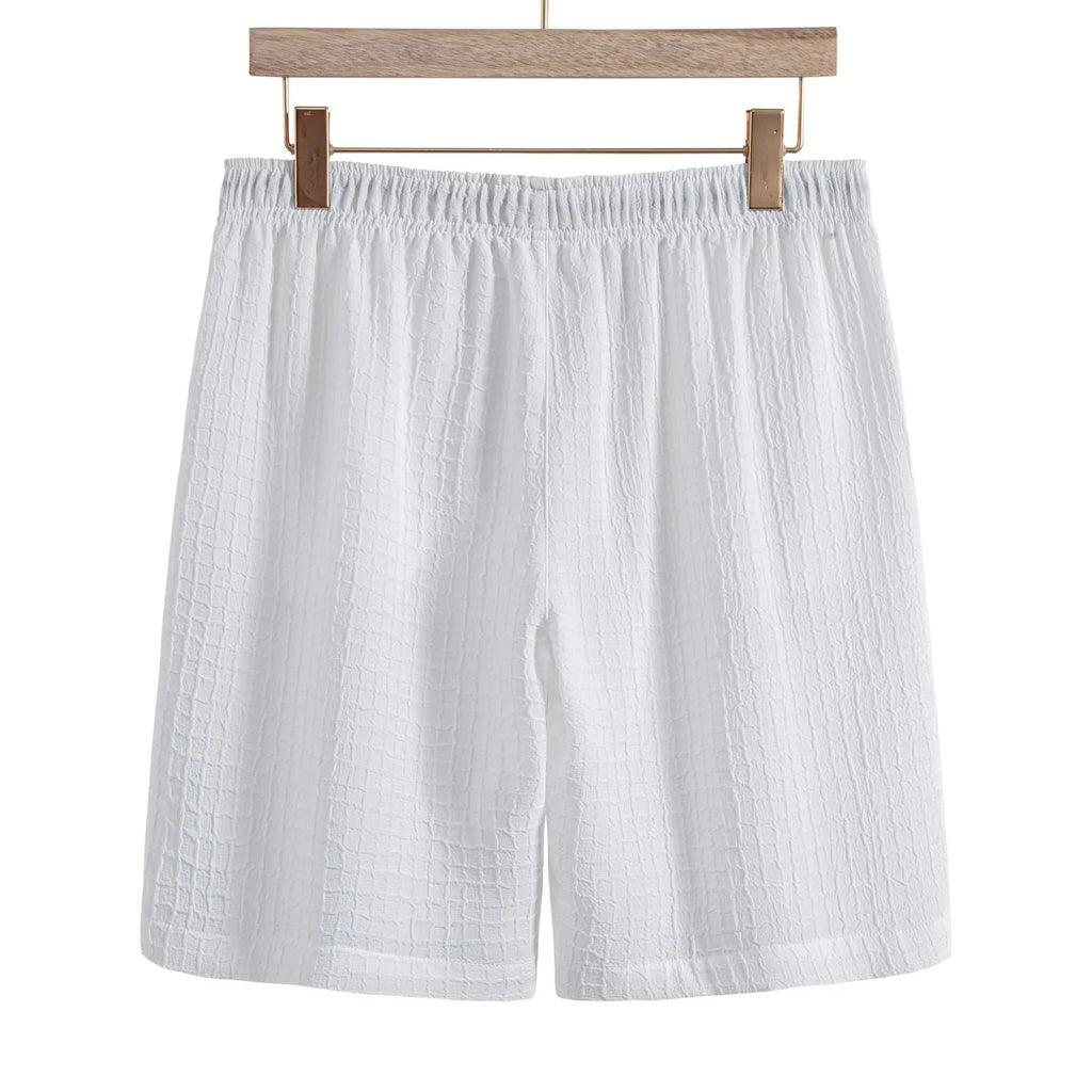 Men's white cotton blend jacquard shirt and matching shorts casual suit set laid flat.
