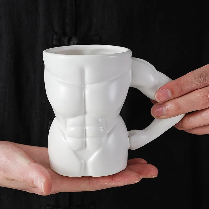 Matte black ceramic mug with muscle man design and 300ml capacity.