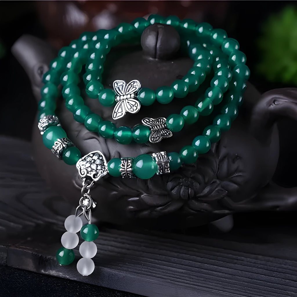 Close-up of a green agate multi-layer bracelet with three strands of 6mm round beads.