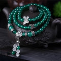 Close-up of a green agate multi-layer bracelet with three strands of 6mm round beads.