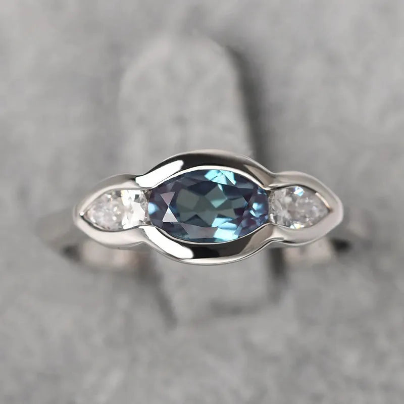 Geometric ellipse copper ring with zircon inlay, white gold colour finish, shown in size options 6-10