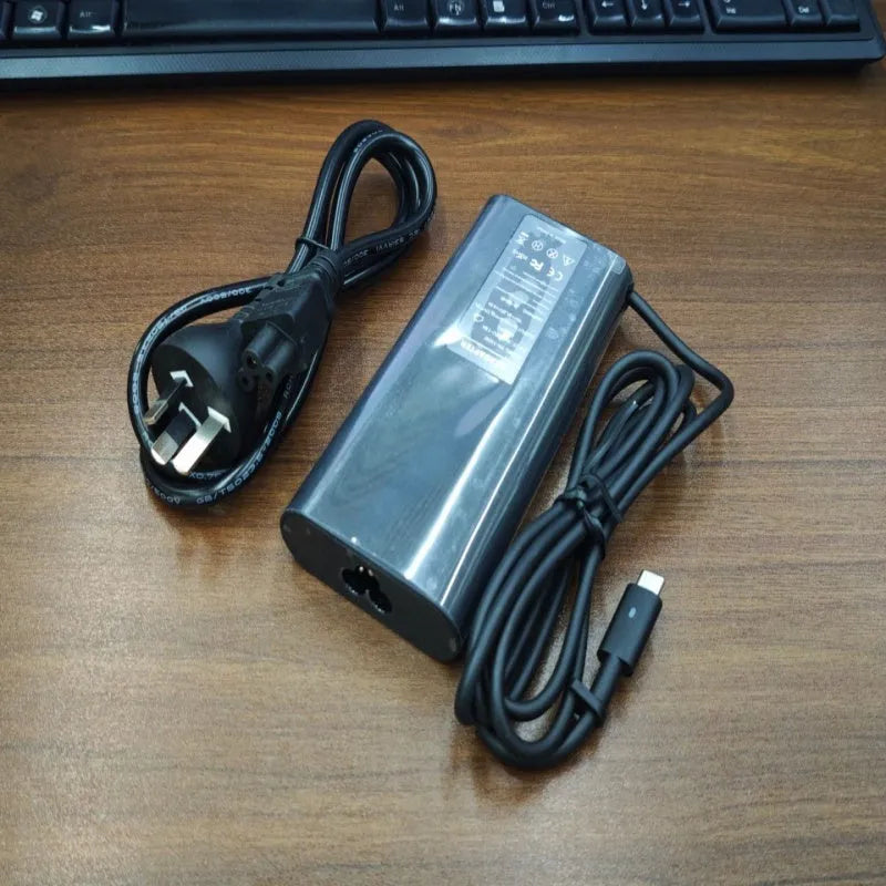 Black 65W USB Type-C laptop power adapter with international travel plug set