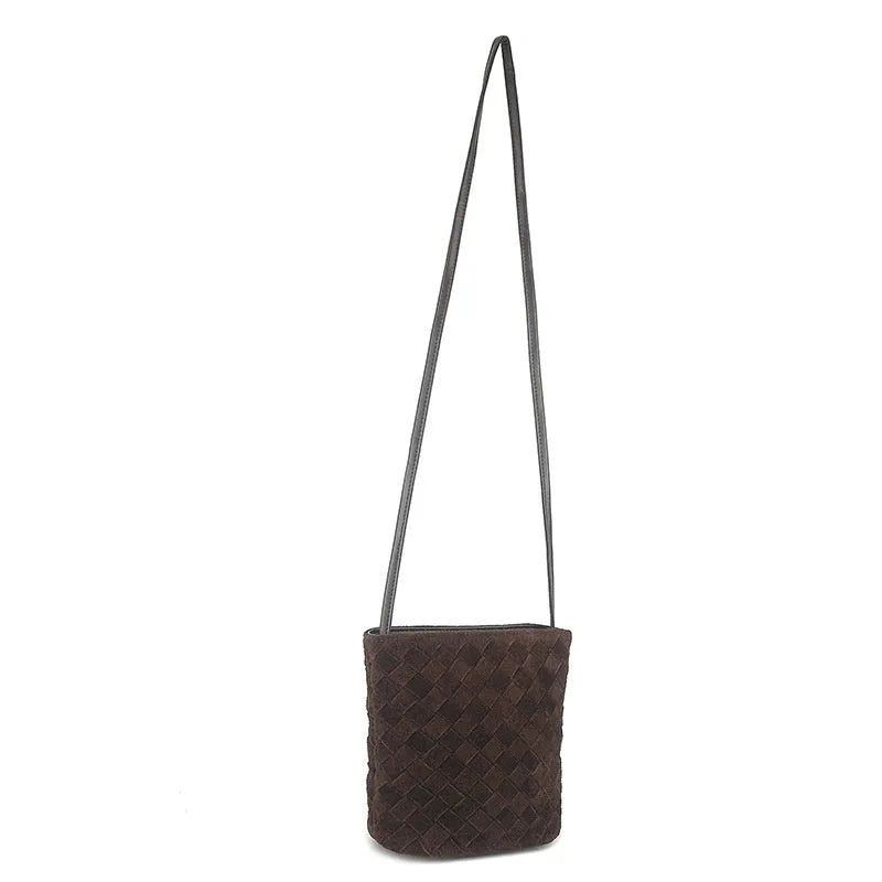 Cowhide leather women's crossbody bag with barrel shape, zip closure, woven detail, and inner patch pocket.