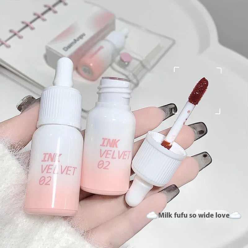 Mirror Lip Lacquer moisturising lip gloss tube in sheer shades on a plain background.