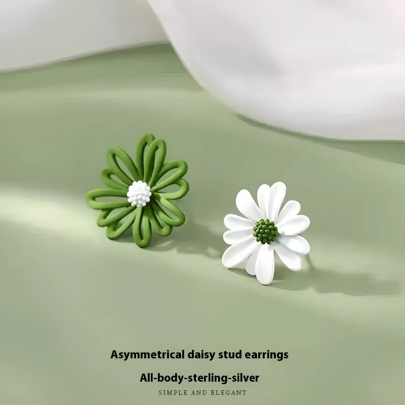 A pair of alloy flower stud earrings in a blue and orange two-tone colour contrast on a white background.