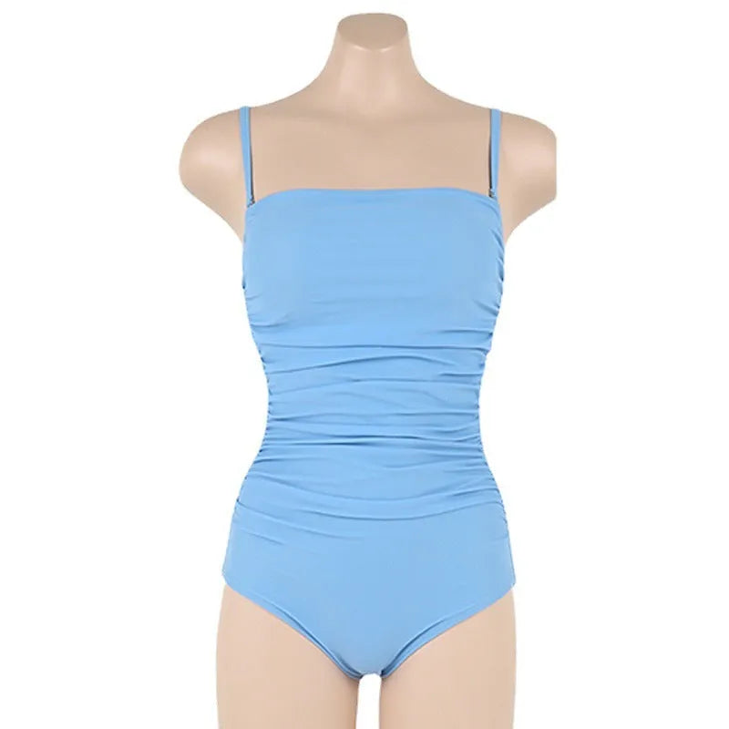 Sling style one-piece swimsuit with belly pleats in black, blue, white, or yellow on a model