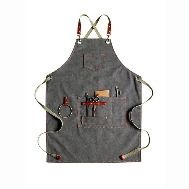 Canvas apron with cross-back straps in camel colour, shown on a person for milk tea shop or cafe use