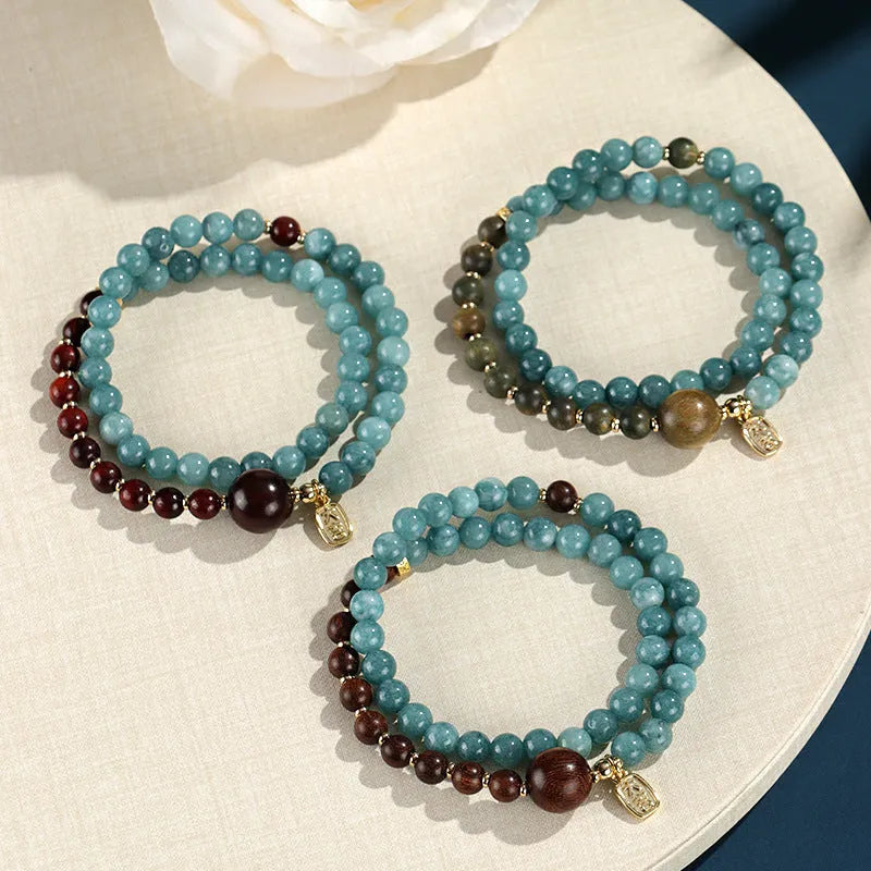 Blue natural stone beaded bracelet with golden sandalwood, guajacwood, or rosewood beads featuring fu and xi characters
