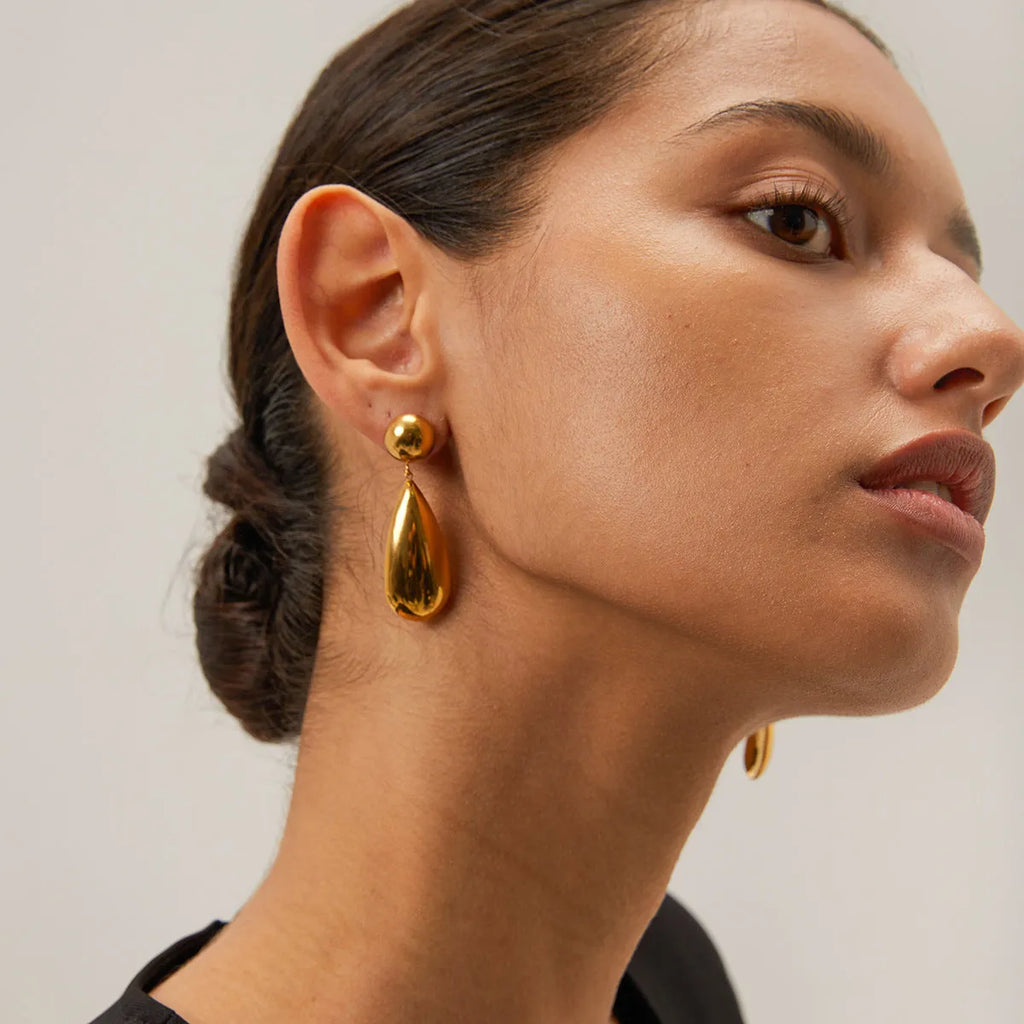 Gold electroplated stainless steel earrings with geometric hemisphere and water drop pendant design