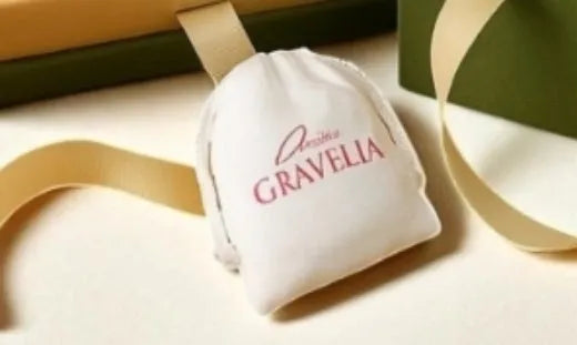 White small cloth drawstring jewellery bag with flocked fabric, measuring 12cm by 15cm.