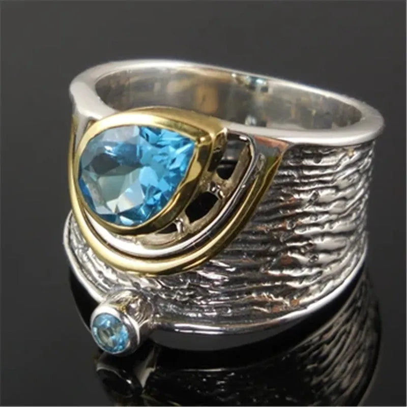 Drop-shaped blue zircon ring with inlaid stones on alloy band, showing sizes 6-10 for women's jewellery.