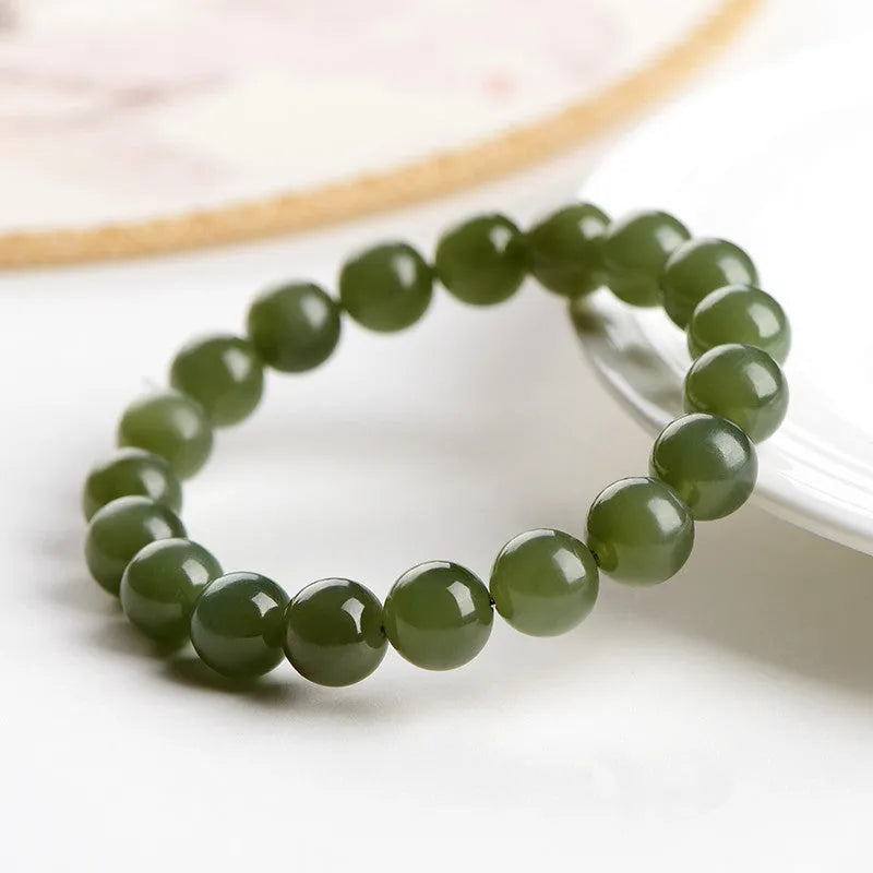 Hetian jade ball bracelet with polished beads in ice-like clear water colours, showing 4mm to 10mm size options