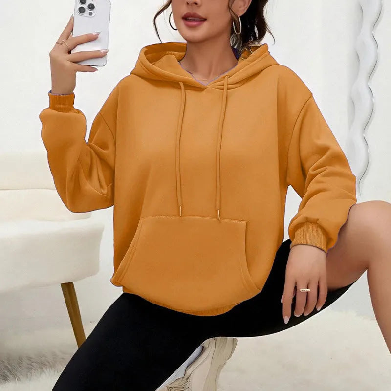 Women's loose grey sweatshirt with long sleeves and a front drawstring pocket, shown in a relaxed fit.