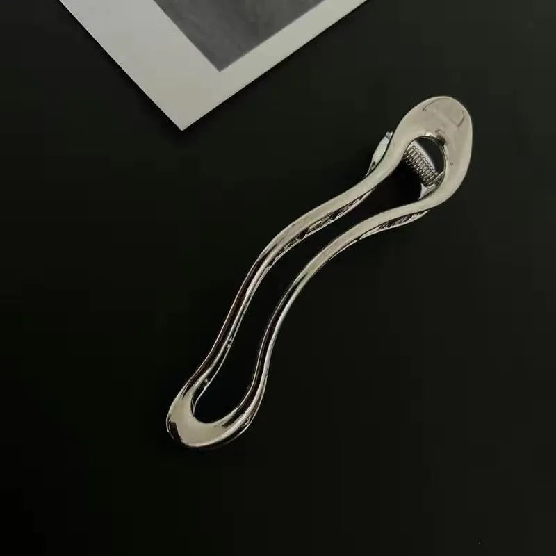 Women's zinc alloy barrettes in gold and silver colours showing arc, square, and triangle shapes