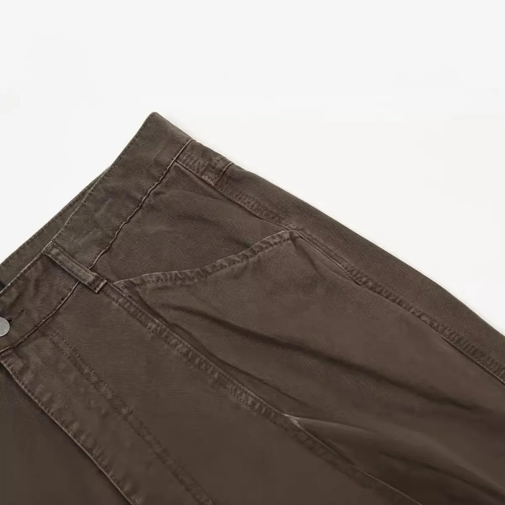 Men's brown straight-leg trousers with high waist and non-ironing cotton fabric on a hanger