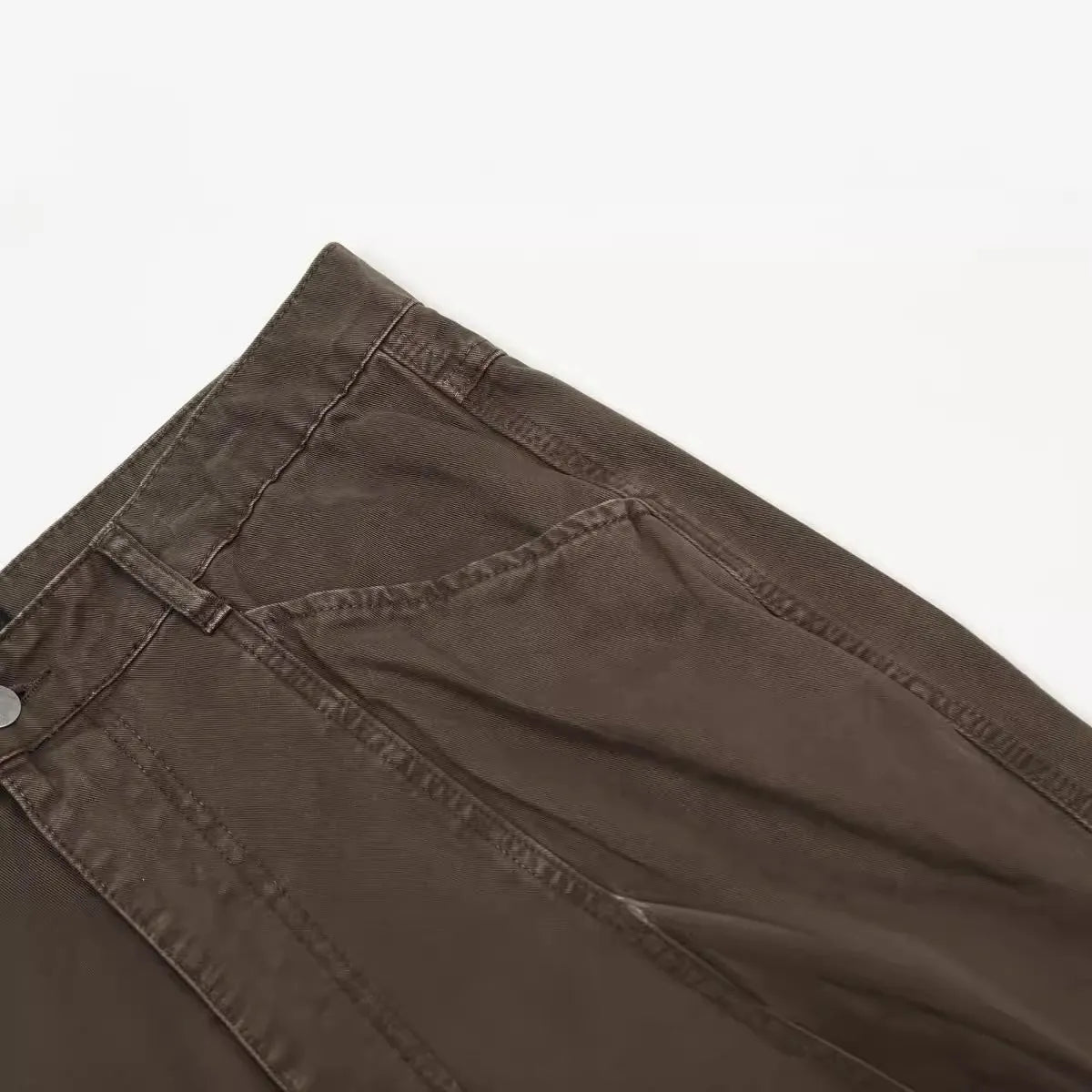 Men's brown straight-leg trousers with high waist and non-ironing cotton fabric on a hanger