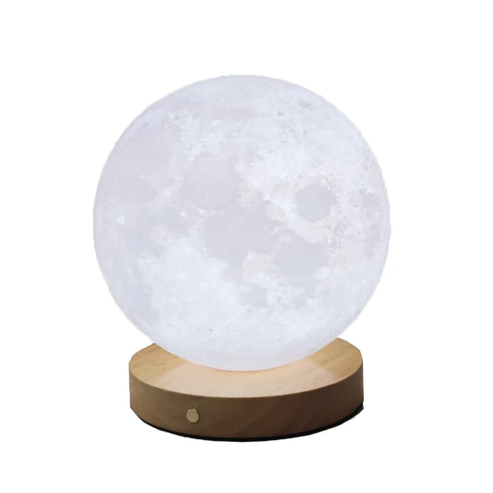 Rotating sleeping moon night lamp on a wooden base, showing three-colour light options.