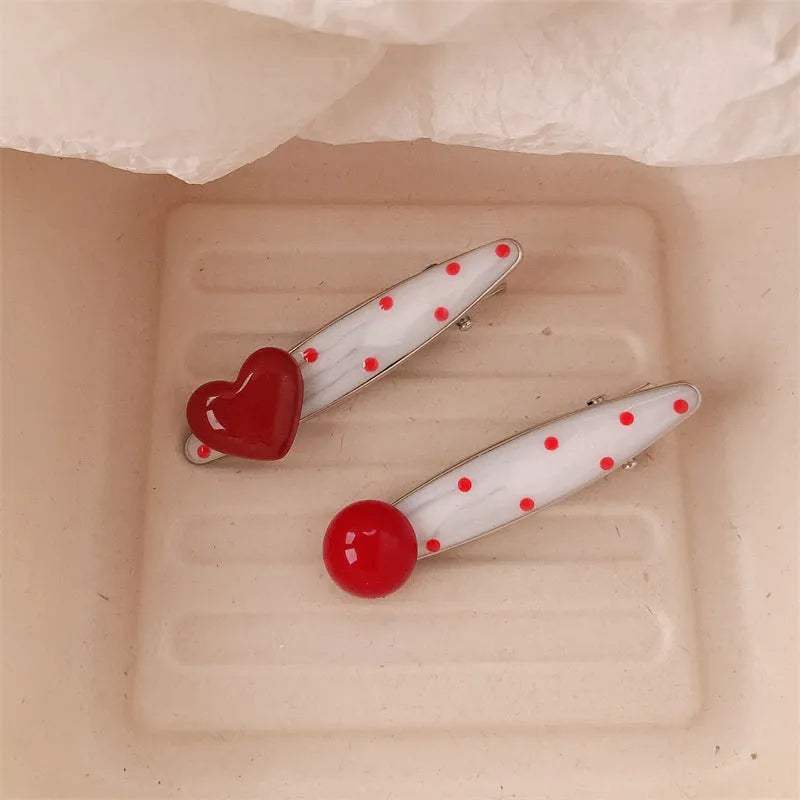 Red three-dimensional love heart-shaped hair barrette with retro dots and a willow leaf design.