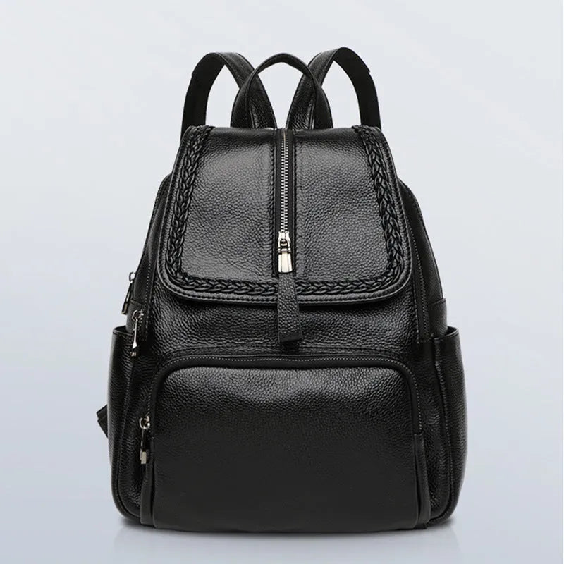 Solid colour genuine leather women's backpack showing blue exterior with multiple compartments and internal organisation