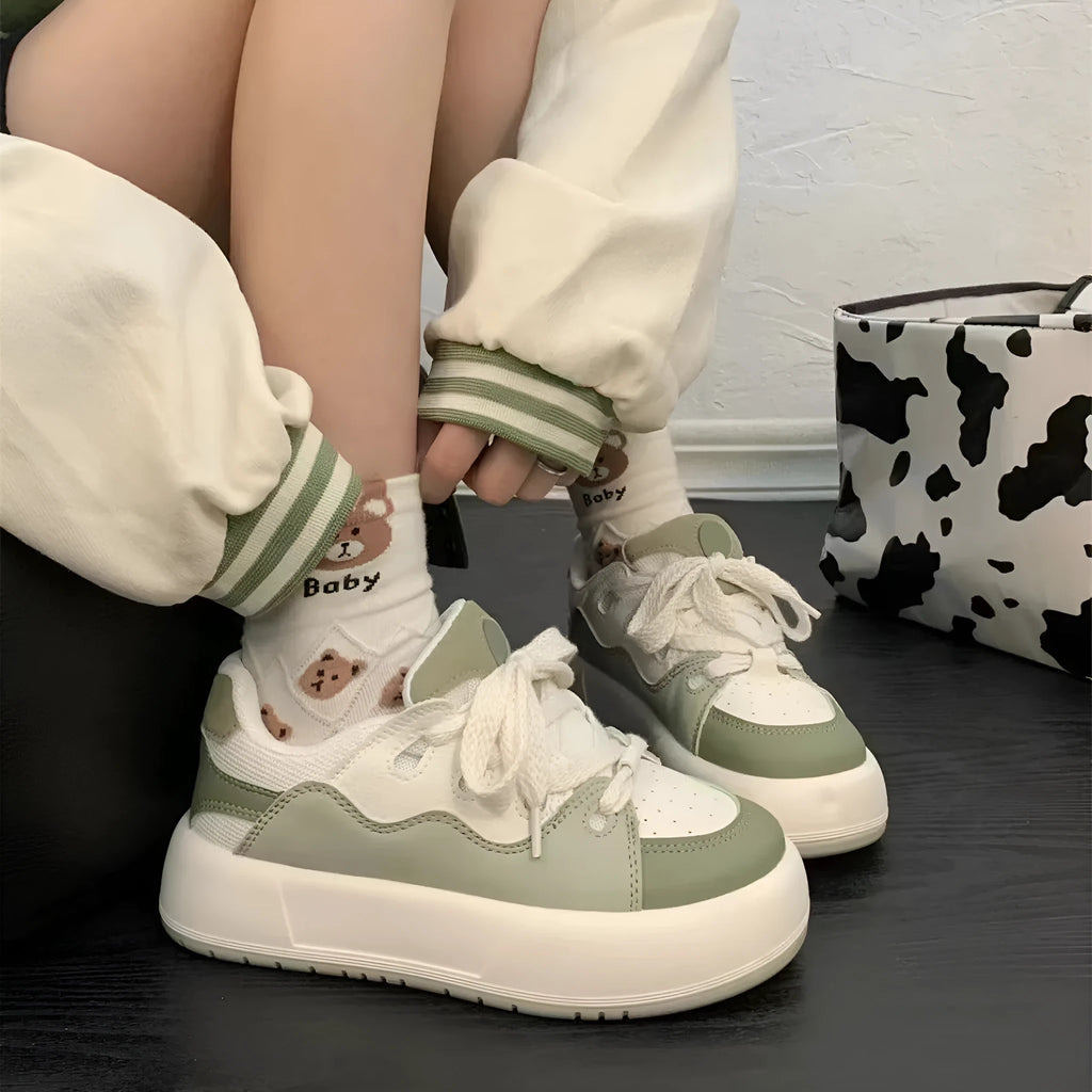 Green women's casual flat shoes with a PU mesh upper and round toe on a plain background.