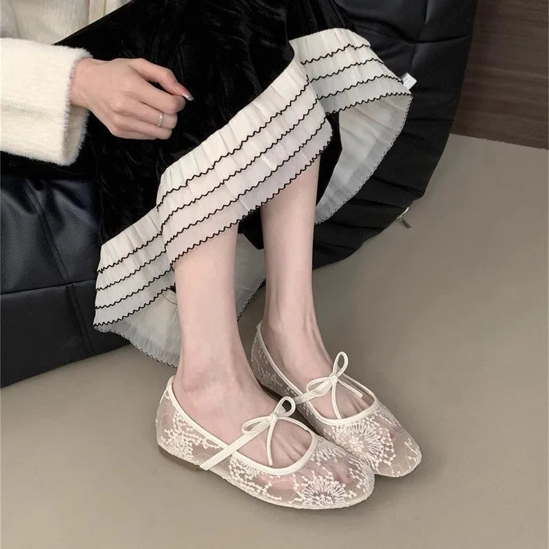 Women's flat lace mesh Mary Jane shoes in pink with a mid heel and buckle strap.