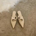 Women's soft leather semi-toe box slippers in black with a rubber sole, shown from the side.