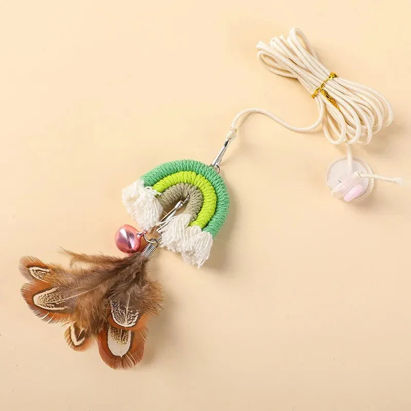 Blue feather cat rope hanging from a door on an elastic swing with a sticky buckle clamp.