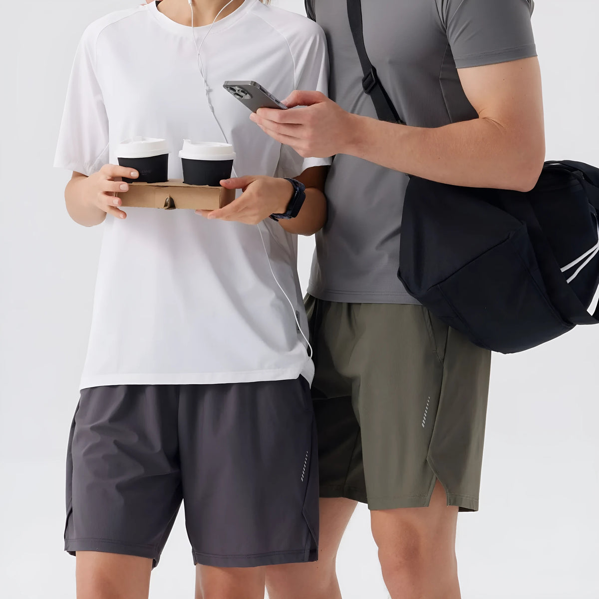 Man wearing black ice silk sports shorts, showing mid-waist fit and shorts length.