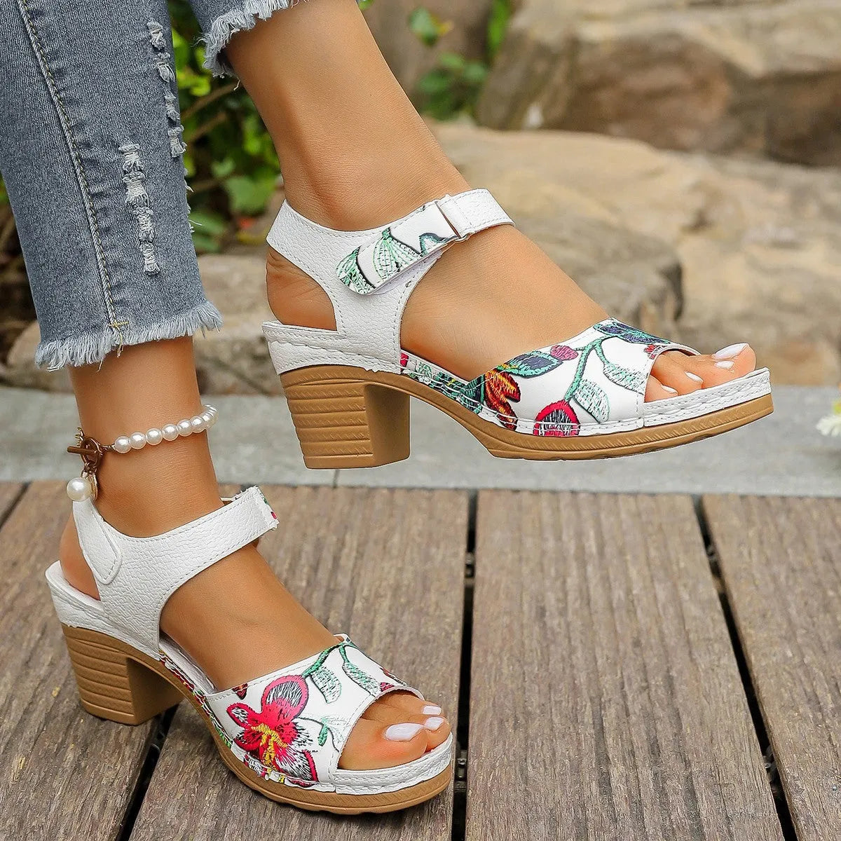White women's high heel sandals showing velcro buckle fastening and rubber sole