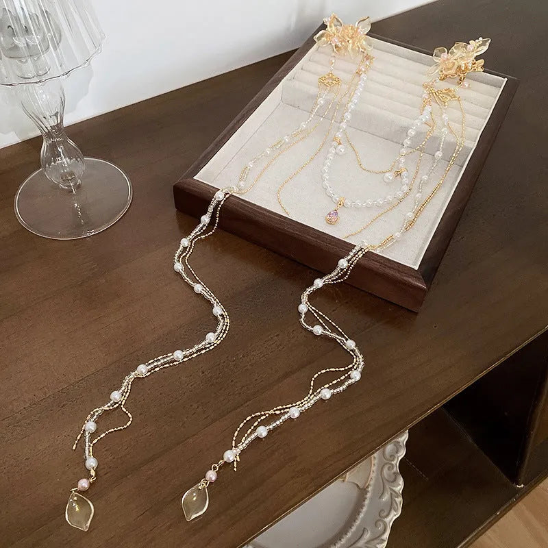 Women's pearl diamond flower long tassel hairpin with gold grip and decorative elements