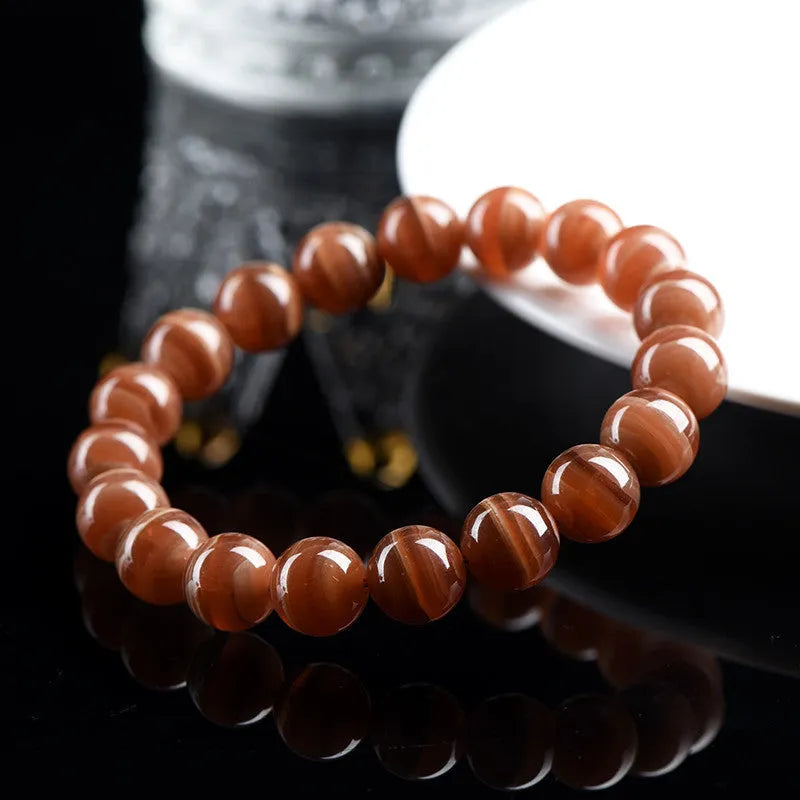 Natural rhodochrosite bracelet with round manganese spar beads and Ruyi decorative elements