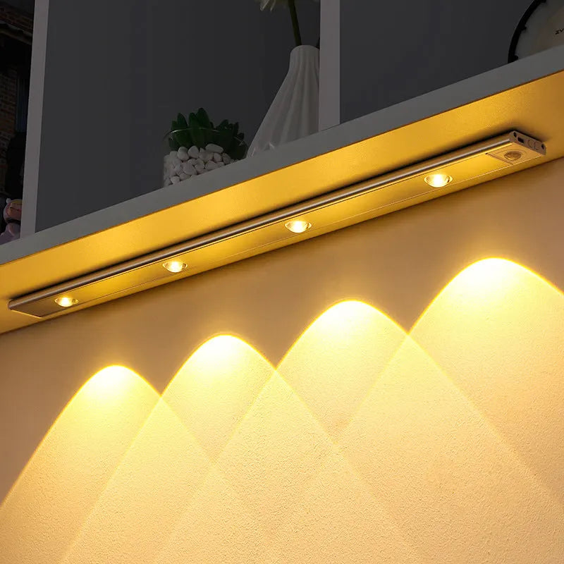 Ultra-thin USB LED night light with motion sensor in silver or black, showing magnet attachment for cabinets