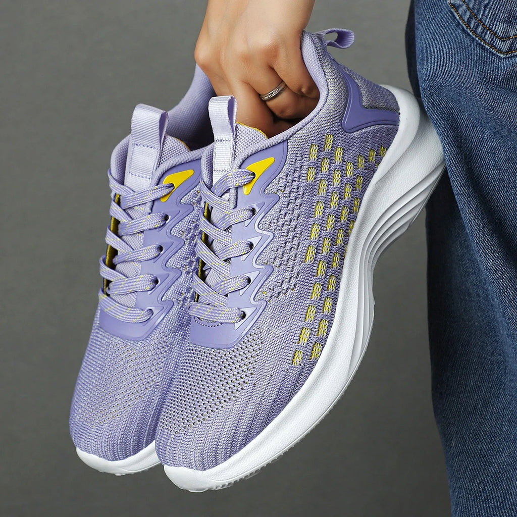 Women's lavender purple Flyknit running shoes with stripe pattern and mesh lining.