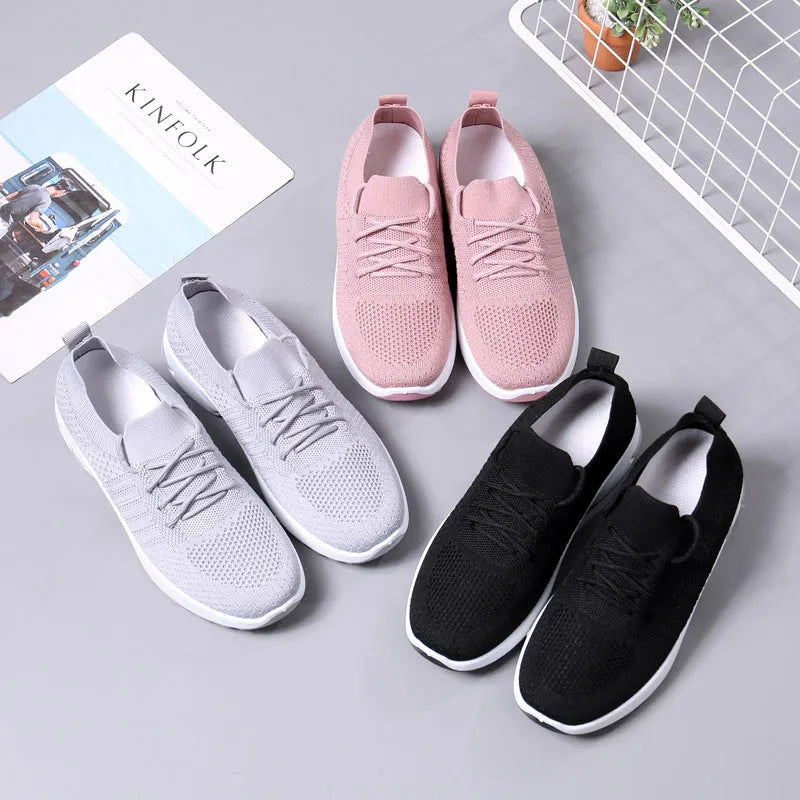 Women's black mesh sneakers with round toe and lace-up front on a white background
