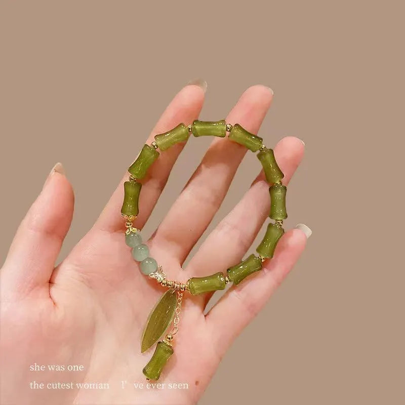 Chinese style bamboo leaf bracelet for women in glass with bamboo joint elements, showing manual processing and colour variations