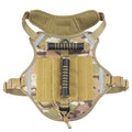 Monochrome tactical dog harness with a back handle and chest strap on a dog.