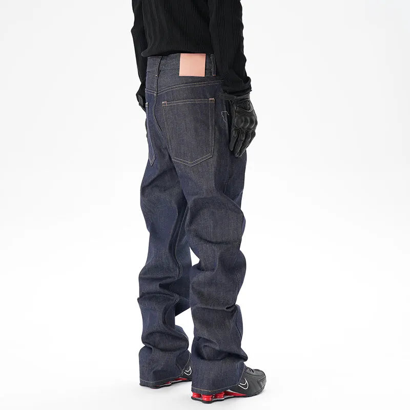 A pair of dark blue loose straight-leg men's jeans on a plain background.