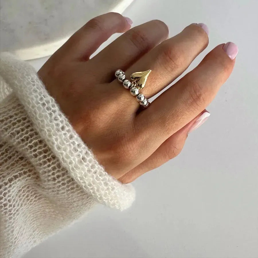 Handmade beaded elastic love ring with geometric heart design in gold and white colour options