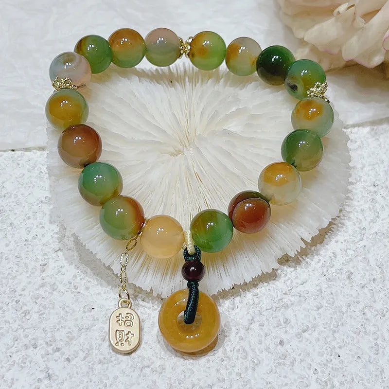 Yellow peacock agate and topaz bracelet with a peace buckle clasp and a lutong agate charm.