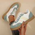 Women's low-top retro sports pumps in a candy colour with cross-strap detail on artificial PU upper.