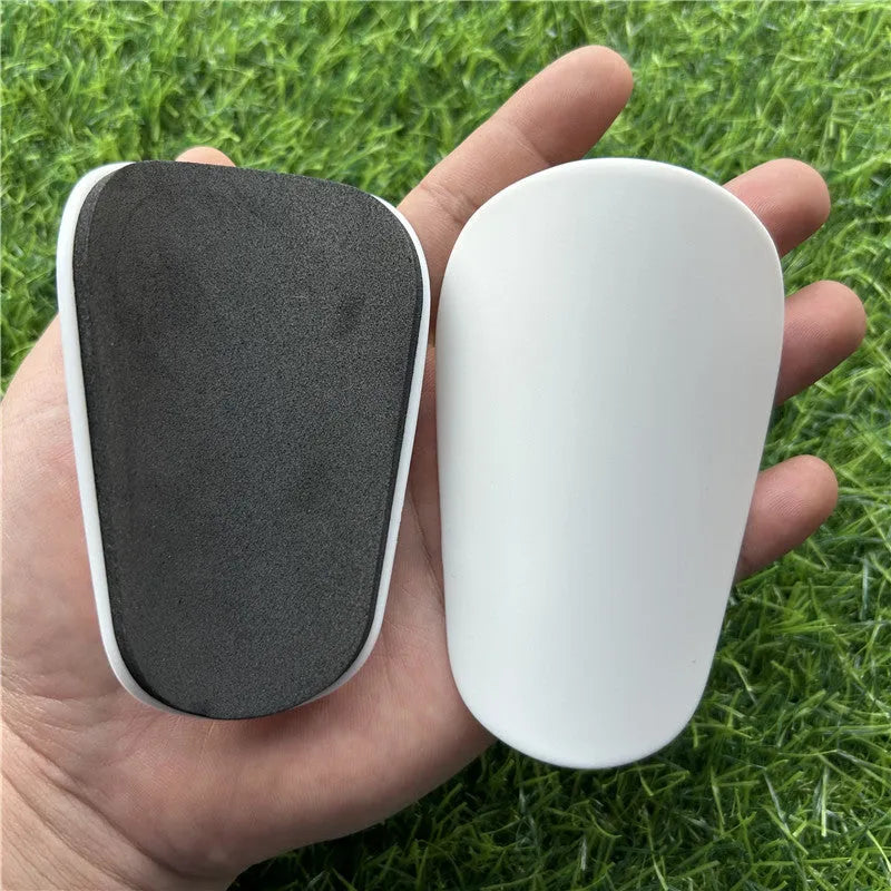 Extra small mini football shin guards in black and white measuring 8x5cm