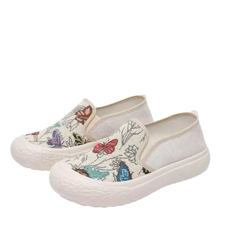 Women's black and white canvas slip-on shoes with round toe and decorative sewing thread details