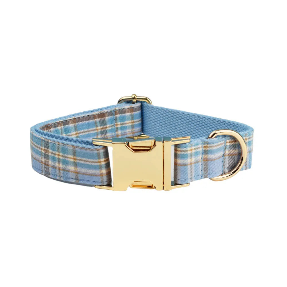 Sky blue and white grid pattern dog collar, leash, bow, and vest four-piece pet accessory set.