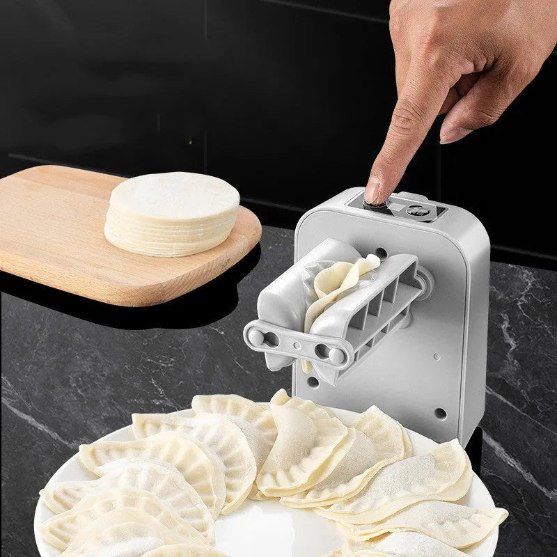 White electric dumpling maker machine with USB charging cable, brush, and spoon.