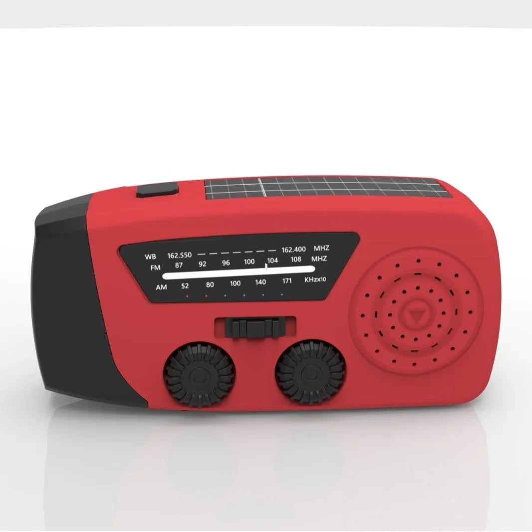 Red rechargeable handheld torch and radio with wrist strap and USB charging cable.