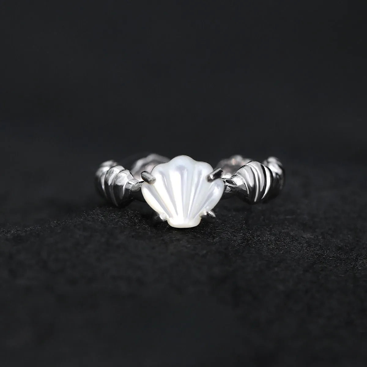 Adjustable silver ring with shell and tiger eye accents in gold electroplated finish showing opening mechanism