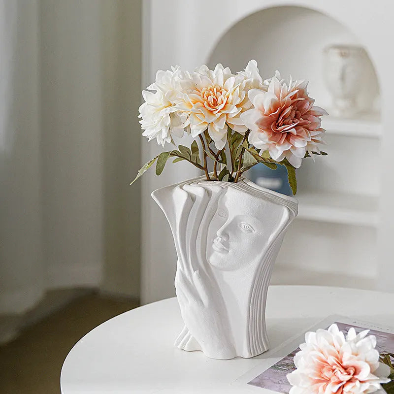 Ceramic book stand in lover design with glazed surface, approximately 15cm tall, on a wooden desk