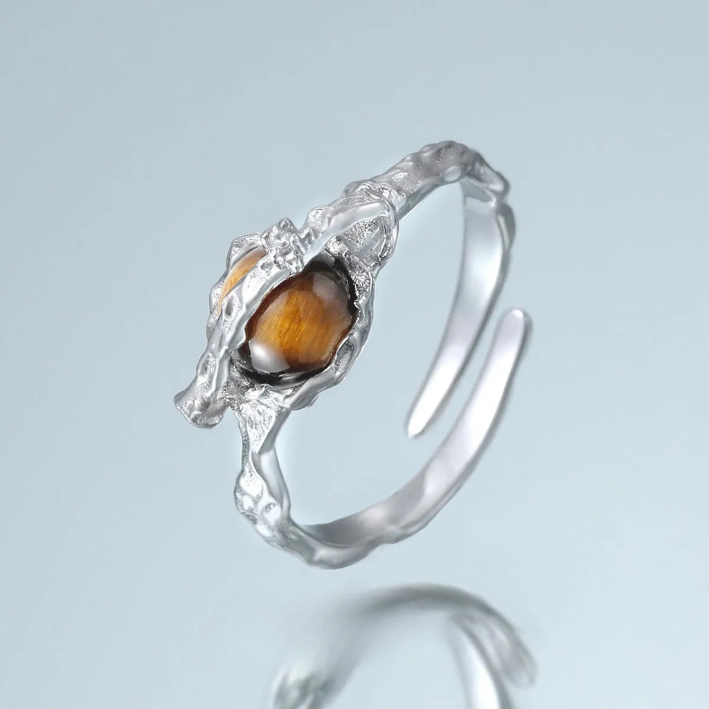 Women's adjustable Saturn open ring in electroplated white gold colour showing original design and adjustable opening mechanism