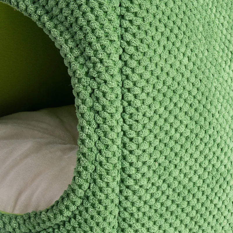 Green cactus-shaped enclosed cat bed with soft fluffy fabric and a plush interior for pets.